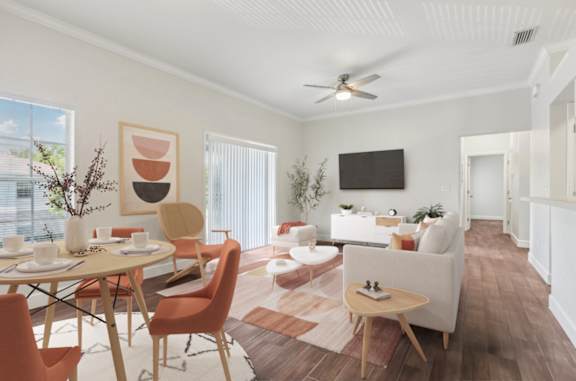 A living room with a dining table and chairs.